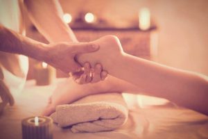 Close-up of a relaxing foot massage during a yoga and wellness retreat in Ericeira at Moka Surfhouse.