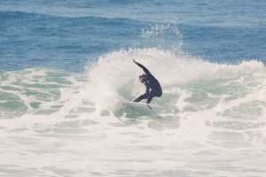 Surfer performing a powerful turn on a wave at Coxos, one of Ericeira’s top surf spots, during a guiding session.