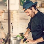Chef David Macaluso preparing vegetarian and vegan Italian food in the kitchen at Moka surfhouse in Ericeira, Portugal.