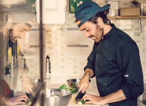 Chef David Macaluso preparing vegetarian and vegan Italian food in the kitchen at Moka surfhouse in Ericeira, Portugal.